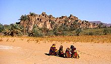 The ruined city of Djado, with nomadic women gathered in the foreground. October 1989. Djado-fern.jpg