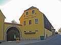 Residential stable house and three side buildings of a four-sided courtyard with an associated archway