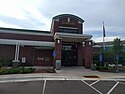 Edina Library, a brick building with an arched entryway and a rectangular concrete pavilion over the entrance, pictured in 2018