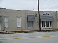 An antiques shop occupies part of the building which once housed the St. Elmo Hotel, long ago destroyed in a fire. Former St. Elmo Hotel, Henrietta, TX IMG 6839.JPG