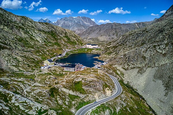 View of the pass and hospice from Great St Bernard Lake with Mont Vélan in background