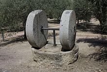 An edge mill with two millstones. Katherine Maltwood portrayed a similar arrangement in her bronze, The Mills of God (1918/9), which was inspired by the suffering of the Great War. Hacienda La Laguna-Museo del Olivar Y del Aceite-Molino antiguo-20110918-09618.jpg