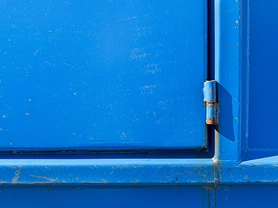 Hinge on blue dumpster