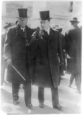 John D. Rockefeller Sr. and Jr. in 1915 John D. Rockefeller, full-length portrait, walking on street with John D. Rockefeller, Jr. LCCN2005685460.tif