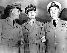 Three men in neat uniforms smiling. MacArthur is wearing his distinctive cap and no tie.