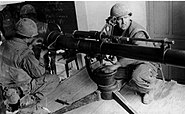 Marines firing a 106mm recoilless rifle from classroom in Hue University