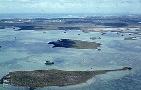 Nassau, taking off. Islands in shallow lagoon. 2 boats (38840256642).jpg