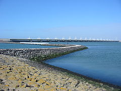 Sea wall in the Netherlands that does allow the tide and organisms through, but brakes wave energy.