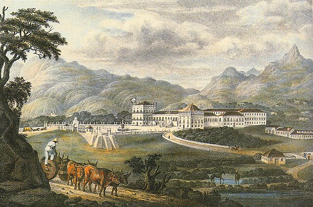 A colored lithograph depicting a large, white palace complex with a carriage entering a paved forecourt and forested mountains rising in the background.