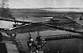 Utmudring av nytt elveløp av Nidelva 1952 ved utbyggingen av Pir II i Trondheim havn endret elvemunningen. Arbeidet foregikk med sandsuger, muddermaskiner og dumpelektere langs elvemoloen for fyllingsmasser.