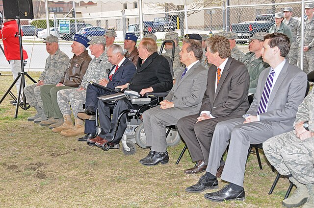 Magaziner (seated on the right in the front row) and other Rhode Island National Guard and political leaders attending a ground breaking ceremony for 