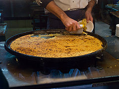 French socca just coming out of the oven, in the old town of Nice, on the French Riviera