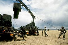 Soldiers from the 31st Air Defense Artillery Brigade conducting reload from a Guided Missile Transporter (GMT) Soldiers from the 31st Air Defense Artillery Brigade at work.jpg