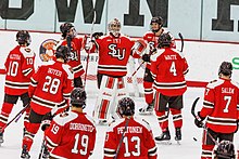 Saints celebrate a win over the Brown Bears in 2023 St. Lawrence Saints mens ice hockey players.jpg