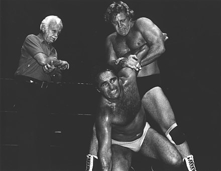 Tommy Seigler applies a hold to Nick Kozak while a referee looks on