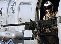 US Navy 041231-N-5345W-054 Aviation Warfare Systems Operator 3rd Class Ryan Branco mans a .50 caliber machine gun.jpg