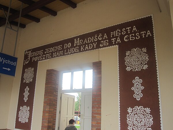 A mural at Uherské Hradiště railway station with two lines of poetry written in an Eastern Moravian dialect