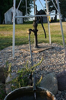 Reciprocating pump attached to a Windmill on a farm. Windmill operated water pump.jpg