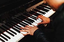 A pianist playing a piano Yamaha piano player (Unsplash).jpg