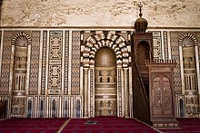 Interior of the Mosque, featuring mihrab and minbar. mnbr msjd lnSr mHmd bn qlwwn.jpg