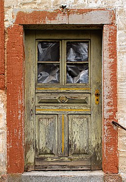 Weathered entrance door of an old residential house