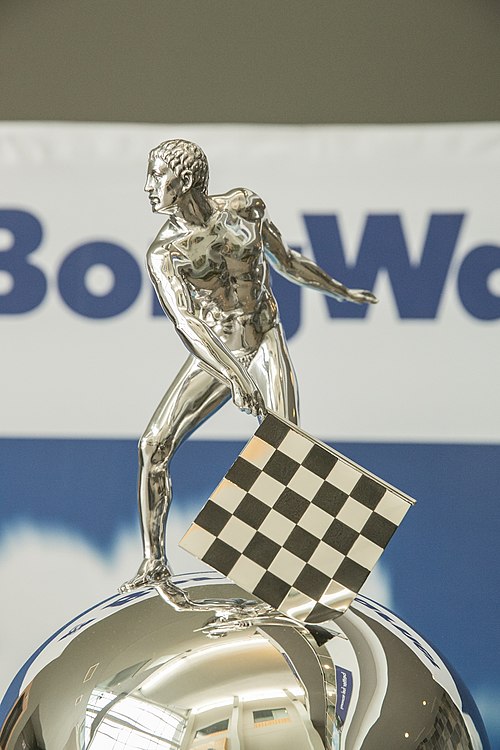 Detail of the image of a man on the top of the Borg-Warner Trophy. Because this man is depicted naked, after the tradition of ancient Greek athletes, 