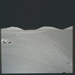 Exploring Shorty crater during the Apollo 17 mission to the Moon. The orange soil was found to the right of the rover, at the base of the small hill at the crater rim.