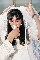 A sip of wine under the wedding canopy A JEWISH BRIDE FROM KIBBUTZ LAVI.jpg