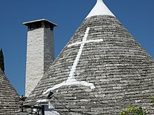 A whitewashed Christian cross on a renovated stone roof. A cross... (6145235744).jpg