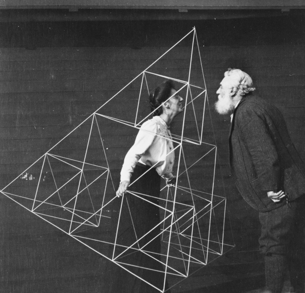 Derived from photographs of Alexander Graham Bell facing and kissing Mabel Hubbard Gardiner Bell, who is standing in a tetrahedral kite, Baddeck, Nova Scotia.