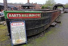 Wrought-iron horse-drawn open barge with the name "Harts Hill Iron Co Ltd" painted on the bow