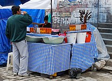 Drinking mocochinchi on a market in La Paz. Drinking mocochinchi in market in La Paz.jpg