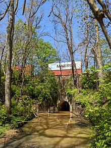Dueling Creek passes through this culvert under the CSX railroad line from Mount Rainier. Dueling Creek MD & CSX train with containers.jpg