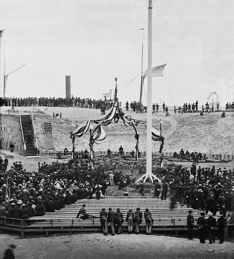 Photograph of American flag being raised at Fort Sumter, Charleston Harbor, South Carolina, on April 14, 1865, one week after Union victory in the Civil War. Major General Robert Anderson and guests are in the audience.  - History By Mail