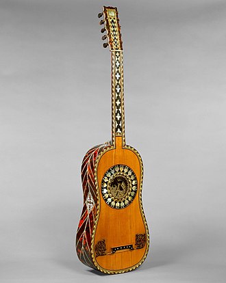 17th-century guitar, attributed to Jean-Baptiste Voboam, part of the Metropolitan Museum of Art collection, is decorated with tortoiseshell, ebony and ivory chevrons, framed scrollwork, lozenges and a gilded rossette with mother of pearl edging. Guitar MET DT1108a.jpg