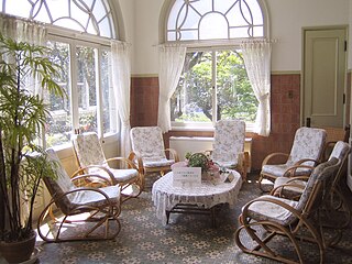 Sunroom room having glass roof and walls, typically attached to a house