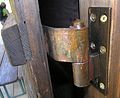 A barrel hinge made of bronze strap.