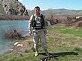 A Kurdish Army Peshmerga "Special Forces" Soldier places his AK-74 assault rifle on the ground to pose for a photograph at a river stream located in the countryside near Dahuk.