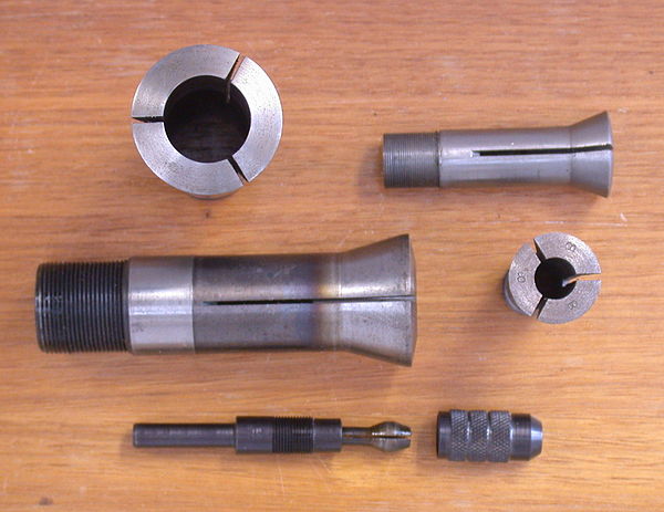 Several machine collets (top and centre) and a dismantled pin chuck (below).