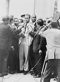 Malcolm X at a 1964 press conference Malcolm X NYWTS.jpg