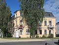 Tenement house with fencing in a corner and open development