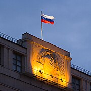 Moskova'daki bir binada yer alan Rusya bayrağı ve SSCB arması