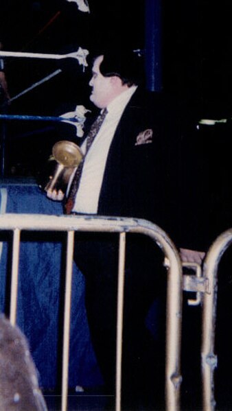 Paul Bearer carrying the urn he used to control The Undertaker