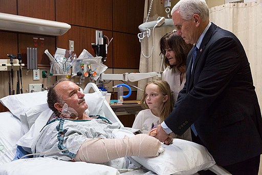 Mike Pence and Karen Pence visiting a victim of the Sutherland Springs church shooting at the Brooke Army Medical Center. Public domain.