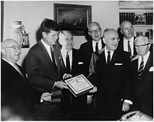 Hoffman (back right) was among those who presented President Kennedy in November 1961 with life membership in the Amateur Athletic Union.