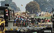 Refugees of the fighting in the Central African Republic observe Rwandan soldiers being dropped off at Bangui M'Poko International Airport in the Central African Republic Jan