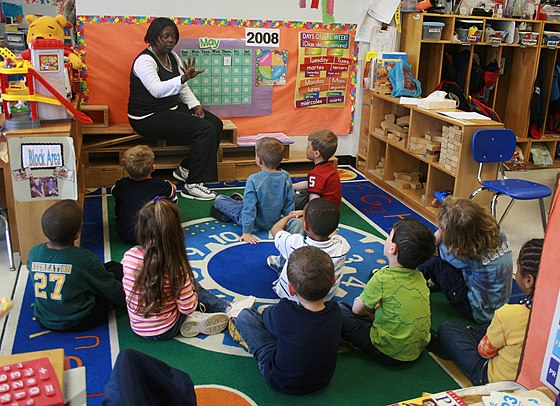 A teacher and her students in an elementary school classroom