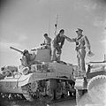 An officer of the Royal Tank Regiment gives orders to a British M3 Stuart commander in the Western Desert, 18 June 1942.