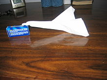 An example of an asymmetrical custom paper airplane, which exhibits large torque due to unbalanced forces on the wings. The flight path assumes a somewhat parabolic shape, before descending in a rapid counter-clockwise spiral, as viewed from behind. Torque paper jet.JPG