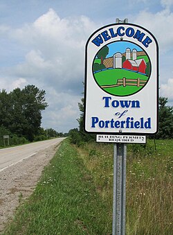 Welcome sign at County Hwy E and State Hwy 64